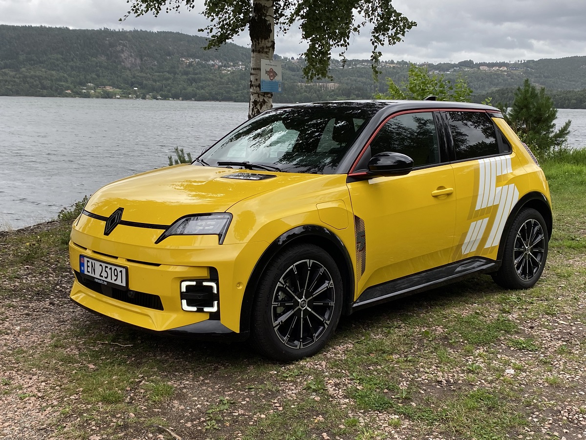 Gul Renault R5 e-tech parkert foran en innsjø